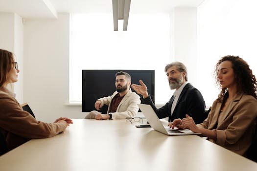 Professional team engaged in a business meeting discussing strategy in a modern office environment.